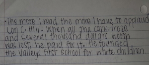 Figure 7. Image description: a photograph of four lines of notes written in black ink on a sheet of notebook paper 