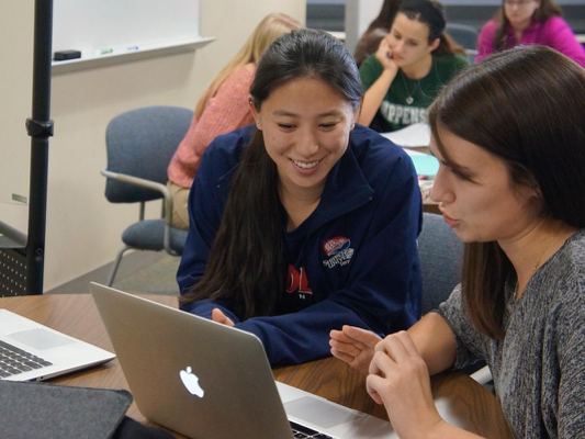 Photo of tutoring session in our writing center.