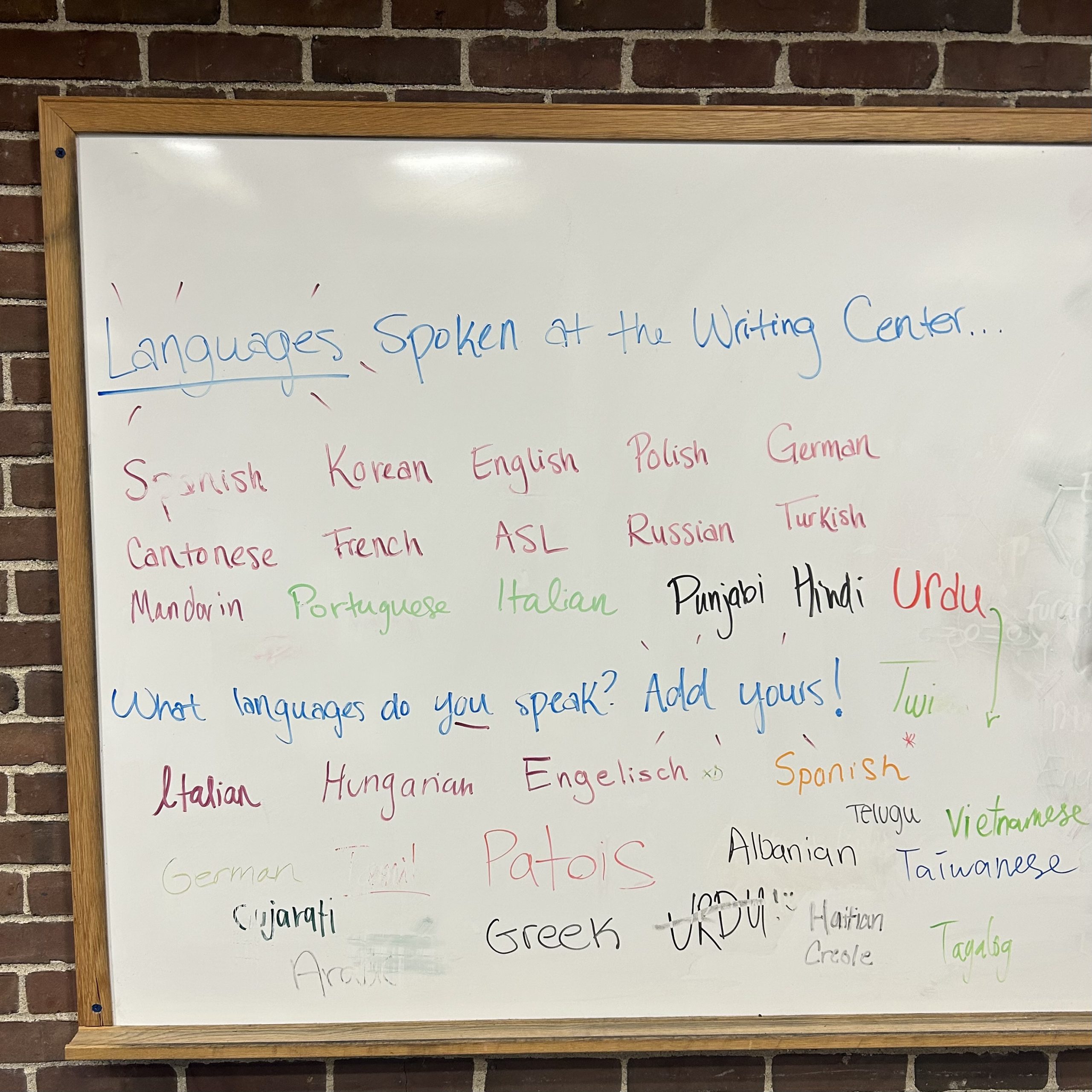 Interactive whiteboard showcasing languages writing center staff know and use and languages visitors to the writing center know and use.